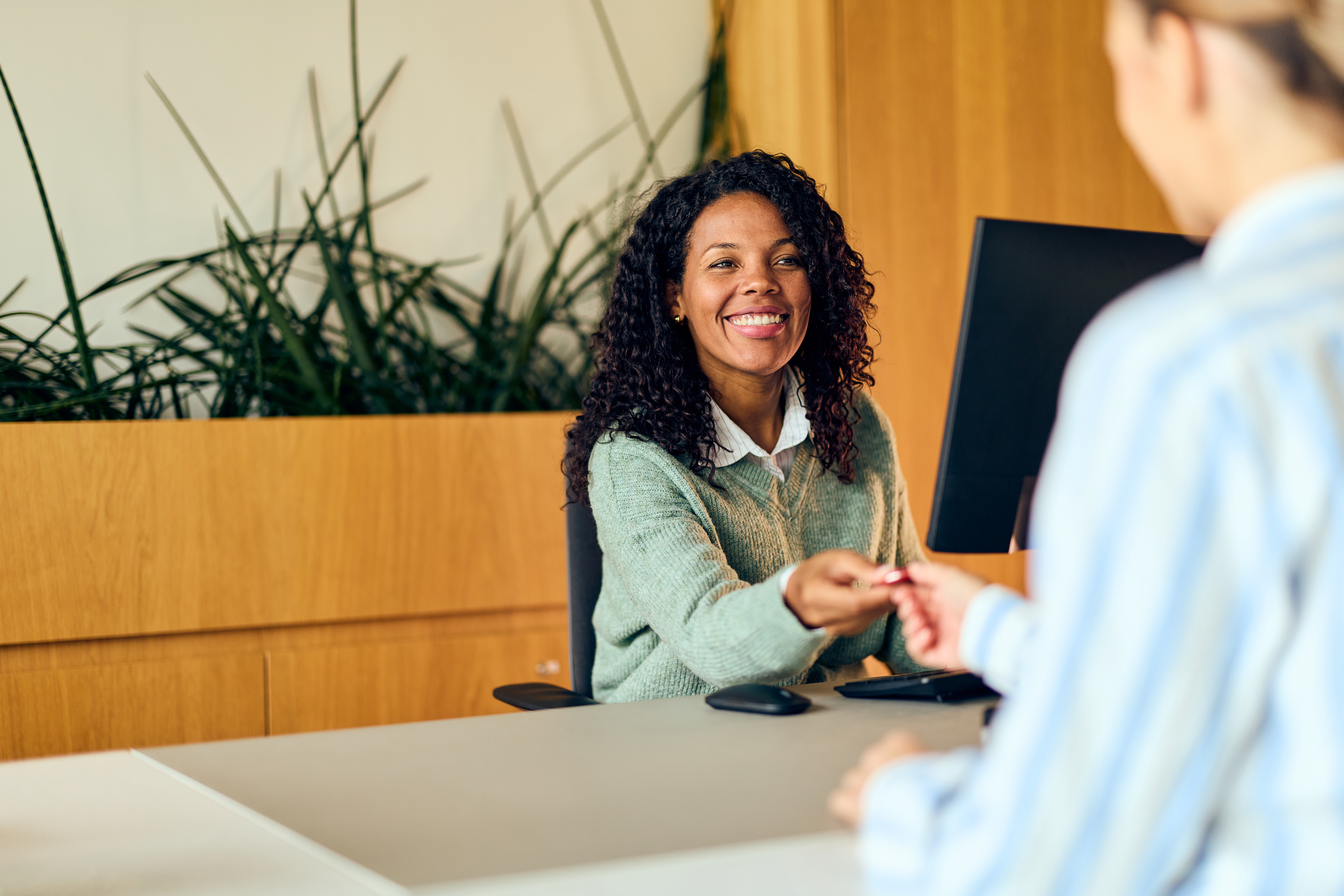 A smiling woman speaking with a banker at a community bank branch in Idaho